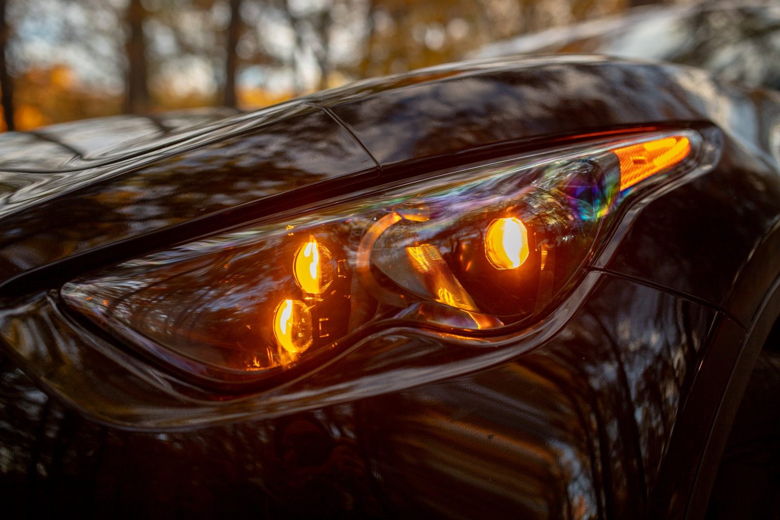 EVO TRI headlight close up with amber DRLs lit inside all three projectors